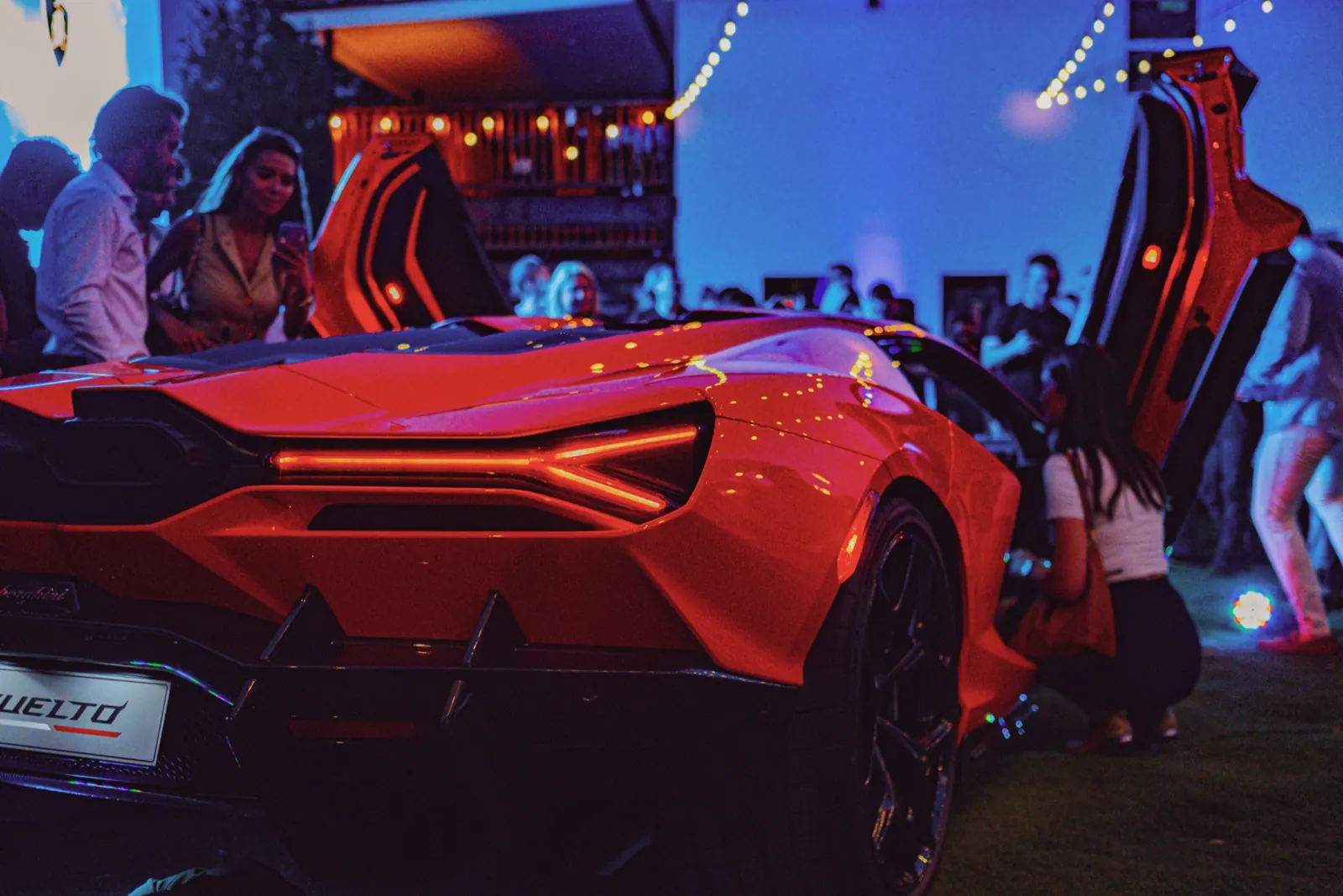 Rear light bar of the Lamborghini Revuelto under party lights at the Austin launch event where DJ Jordan Miller performed