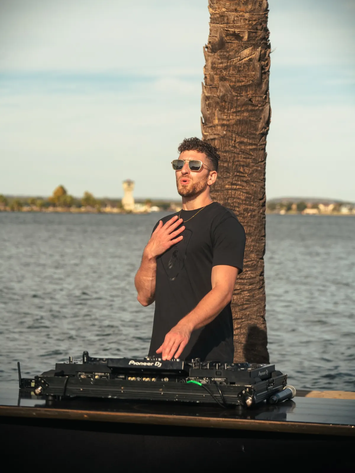 DJ Jordan Miller performing lakeside at a Lamborghini Austin event in 2024