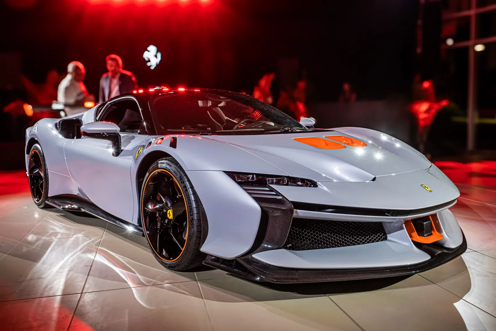 Ferrari SF90 XX Stradale on display under red light at its reveal at Ferrari of Austin, October 2023
