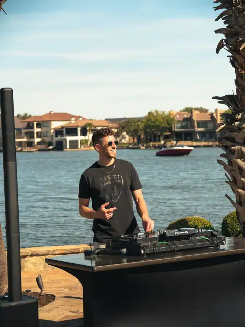 Jordan Miller DJing a Lamborghini Austin event on Lake Austin, 2024, photo 4