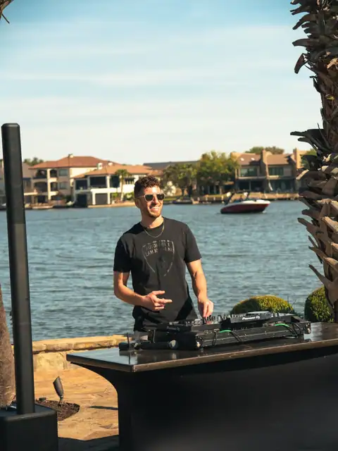 Jordan Miller DJing a Lamborghini Austin event on Lake Austin, 2024, photo 5