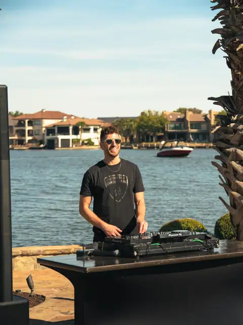 Jordan Miller DJing a Lamborghini Austin event on Lake Austin, 2024, photo 6